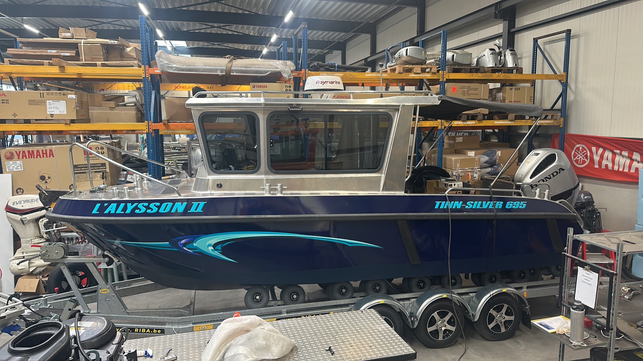 Blue Tinn Silver 695 cabin boat on its trailer