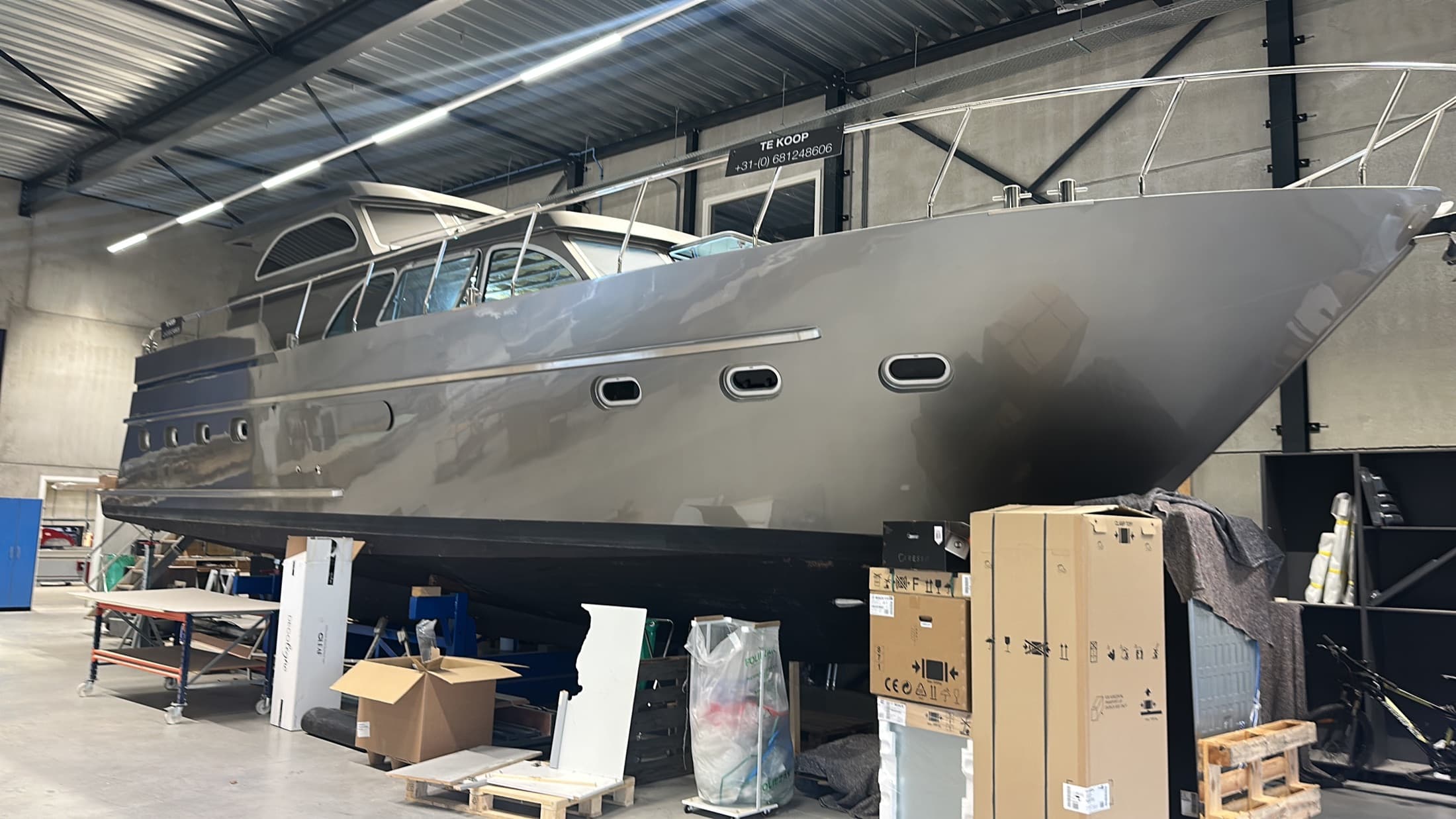 Large custom aluminium motor yacht inside the shipyard
