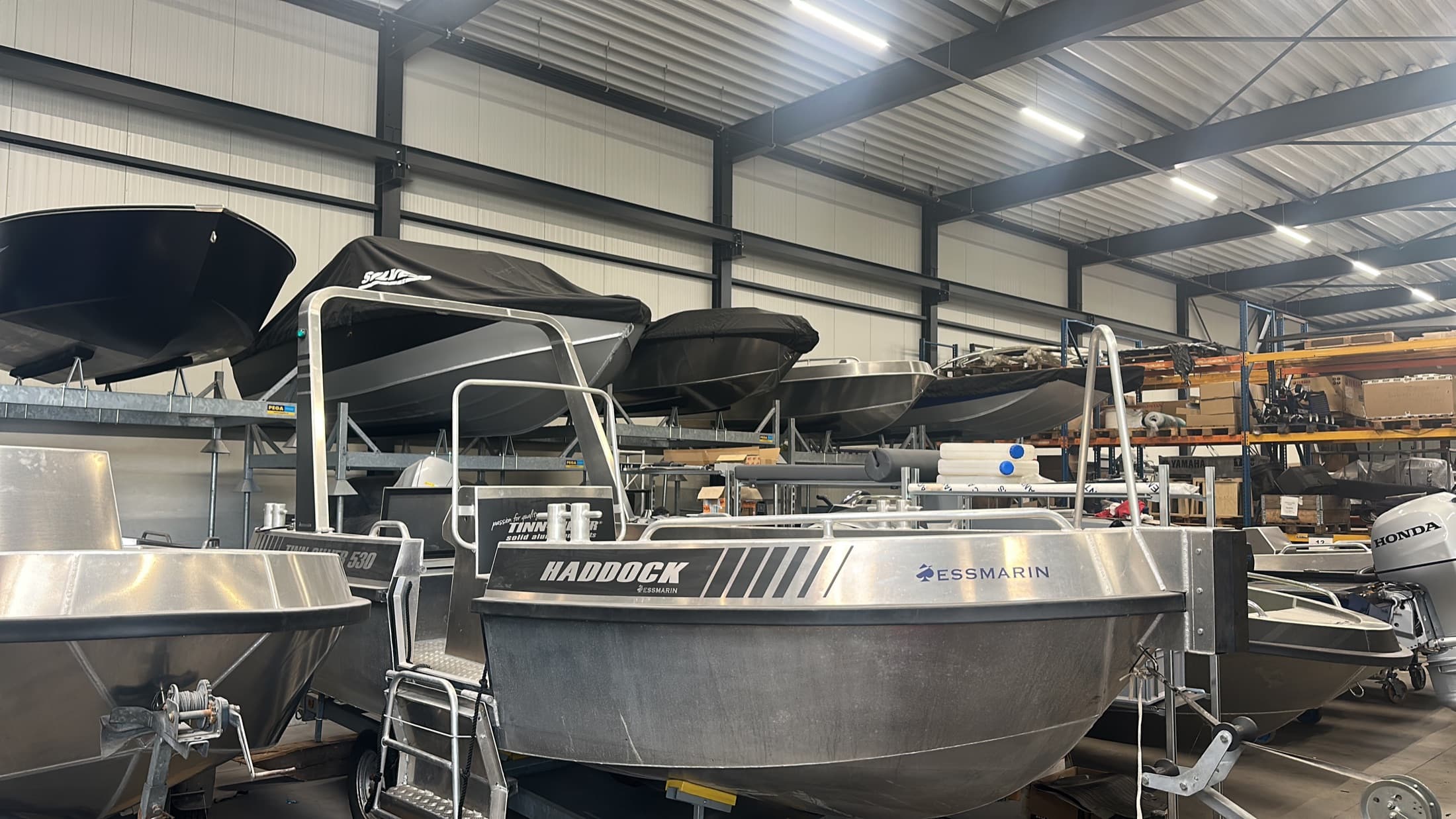 Aluminium workboats lined up inside the workshop