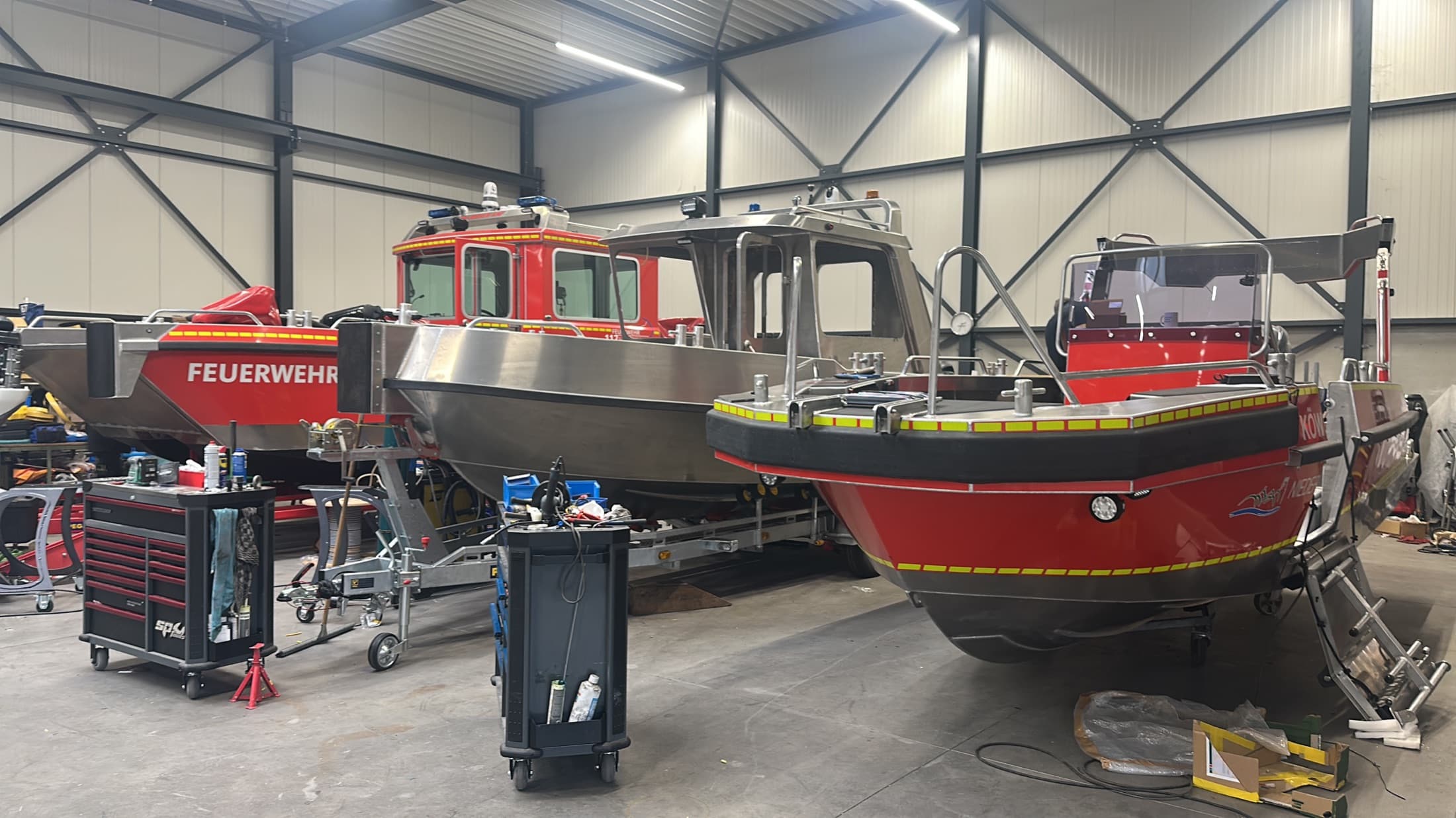 Firefighting and rescue boats together inside the Tinn Silver workshop